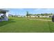Lush backyard, offering serene views of surrounding greenery and homes in the distance at 4623 Wandsworth Way, Davenport, FL 33837