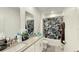 Bathroom featuring double sinks, framed mirrors, and a bathtub with black and white curtains at 4623 Wandsworth Way, Davenport, FL 33837