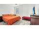 Bright bedroom with an orange bed, ceiling fan, providing a cozy and inviting atmosphere at 4623 Wandsworth Way, Davenport, FL 33837