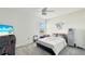 Well-lit bedroom with a neutral color scheme, ceiling fan and views of the landscape through a window at 4623 Wandsworth Way, Davenport, FL 33837