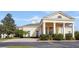 A beautiful clubhouse with tall white columns and manicured bushes at 4623 Wandsworth Way, Davenport, FL 33837