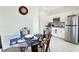 Eat in dining area features ornamental chairs, table, and stainless steel appliances at 4623 Wandsworth Way, Davenport, FL 33837