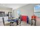 A dining area has an ornamental table, chairs, and stainless steel appliances at 4623 Wandsworth Way, Davenport, FL 33837