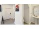 Entryway with a powder room and staircase, accented with artwork at 4623 Wandsworth Way, Davenport, FL 33837