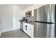 A bright kitchen offers stainless steel appliances, white cabinets, and black countertops at 4623 Wandsworth Way, Davenport, FL 33837