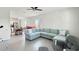 Bright living room features tile floors, neutral paint, and large sectional sofa at 4623 Wandsworth Way, Davenport, FL 33837