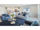 Modern open-concept living room with access to kitchen and dining area filled with natural light at 4623 Wandsworth Way, Davenport, FL 33837