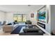 Modern living room with stylish furniture, including a sleek sofa and a decorative wall-mounted fireplace at 4623 Wandsworth Way, Davenport, FL 33837