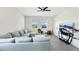 Bright, open living room with natural light, ceiling fan, tile floors, and comfortable seating, perfect for relaxation at 4623 Wandsworth Way, Davenport, FL 33837
