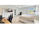 Bright bedroom with a modern ceiling fan, work space, and a sliding barn door to the bathroom at 4623 Wandsworth Way, Davenport, FL 33837