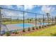 Enjoy a game of pickleball on the community court amid well-maintained landscaping and a secure fence at 4623 Wandsworth Way, Davenport, FL 33837