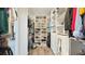 Spacious walk-in closet with custom shelving, providing ample storage for shoes, clothes, and accessories at 4623 Wandsworth Way, Davenport, FL 33837