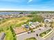 Aerial view showcasing community amenities, including a playground, pool, and clubhouse near the lake at 4717 Weatherbell Rd, Winter Garden, FL 34787