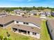 Aerial view of a backyard patio with outdoor seating, lush green grass, and landscaping at 4717 Weatherbell Rd, Winter Garden, FL 34787
