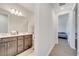 Hallway leading to the bathroom and bedroom with double sink vanity at 4717 Weatherbell Rd, Winter Garden, FL 34787