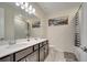 Bathroom featuring double sinks, modern lighting, and a framed mirror, creating a functional space at 4717 Weatherbell Rd, Winter Garden, FL 34787