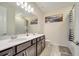 Bathroom featuring double sinks, modern lighting, and a framed mirror, creating a functional space at 4717 Weatherbell Rd, Winter Garden, FL 34787