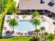 Aerial view of the community pool surrounded by palm trees, lounge chairs, and covered seating at 4717 Weatherbell Rd, Winter Garden, FL 34787