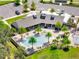 Aerial view of the community pool and clubhouse, featuring palm trees and ample lounging space at 4717 Weatherbell Rd, Winter Garden, FL 34787