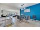 Open dining room features a glass table, modern lighting, and seating for six at 4717 Weatherbell Rd, Winter Garden, FL 34787