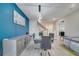 Stylish dining area with modern lighting and a glass table adjacent to the staircase at 4717 Weatherbell Rd, Winter Garden, FL 34787