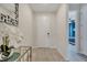 Welcoming entryway featuring neutral colors, a modern mirror, and a decorative floral arrangement at 4717 Weatherbell Rd, Winter Garden, FL 34787