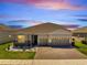 Beautiful house exterior featuring a well-maintained front yard and a three-car garage at 4717 Weatherbell Rd, Winter Garden, FL 34787