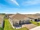 Beautiful one-story home with a two-car garage, green lawn, and stone accents at 4717 Weatherbell Rd, Winter Garden, FL 34787