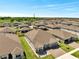Beautiful one-story home with a two-car garage, green lawn, and stone accents at 4717 Weatherbell Rd, Winter Garden, FL 34787