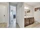 Hallway leading to a bathroom and bedroom featuring doors for privacy and tiled floors at 4717 Weatherbell Rd, Winter Garden, FL 34787