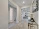 Bright hallway with tile flooring, leading to living spaces and bedrooms, offering a seamless flow at 4717 Weatherbell Rd, Winter Garden, FL 34787
