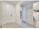 Hallway showcasing doors to bedrooms and bathrooms for easy access, tiled floors, and front door at 4717 Weatherbell Rd, Winter Garden, FL 34787