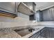 Modern kitchen with granite countertops and stainless steel range hood at 4717 Weatherbell Rd, Winter Garden, FL 34787