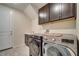 Functional laundry room with washer, dryer, and overhead cabinetry at 4717 Weatherbell Rd, Winter Garden, FL 34787