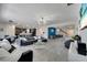 Open-concept living room featuring contemporary decor, tile floors, and modern lighting at 4717 Weatherbell Rd, Winter Garden, FL 34787