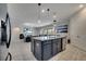 Open-concept living area featuring a kitchen island with pendant lighting at 4717 Weatherbell Rd, Winter Garden, FL 34787