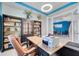 Bright office space with built-in bookshelves and a modern desk setup at 4717 Weatherbell Rd, Winter Garden, FL 34787