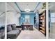 The office boasts custom bookshelves, modern lighting, and a comfortable sofa at 4717 Weatherbell Rd, Winter Garden, FL 34787