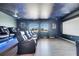 Home theater features luxury seating, starry ceiling, projector, and large screen for entertainment at 4717 Weatherbell Rd, Winter Garden, FL 34787