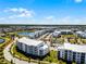 Modern apartment complex includes beautiful lake views, convenient on-site parking, and lush landscaping, with green lawns and mature trees at 4721 Clock Tower Dr # 106, Kissimmee, FL 34746