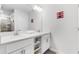 Bright bathroom featuring double vanity, storage, large mirror and coastal themed decor at 4721 Clock Tower Dr # 106, Kissimmee, FL 34746
