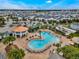 Aerial shot showcasing the community pool with lounge chairs and lush landscaping at 4721 Clock Tower Dr # 106, Kissimmee, FL 34746