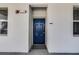 Inviting blue front door, framed by white exterior walls, providing a secure and stylish entrance at 4721 Clock Tower Dr # 106, Kissimmee, FL 34746