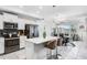Modern kitchen features white cabinetry, stainless steel appliances, and a center island with bar seating at 4721 Clock Tower Dr # 106, Kissimmee, FL 34746