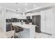 Modern kitchen featuring white cabinetry, stainless steel appliances, and a stylish backsplash at 4721 Clock Tower Dr # 106, Kissimmee, FL 34746