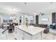 Bright, open concept living space connects the modern kitchen, dining area, and cozy living room at 4721 Clock Tower Dr # 106, Kissimmee, FL 34746