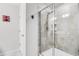 Shower featuring glass doors and neutral colored tile at 4721 Clock Tower Dr # 106, Kissimmee, FL 34746