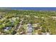 An aerial view of homes nestled in a lush green neighborhood near a serene lake at 4873 Old Oak Trl, St Cloud, FL 34771