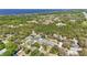 An aerial view showcasing homes nestled in a lush green neighborhood near a serene lake at 4873 Old Oak Trl, St Cloud, FL 34771