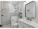 Modern bathroom featuring a glass-enclosed shower, a stylish vanity with a dark-framed mirror and toilet at 4873 Old Oak Trl, St Cloud, FL 34771